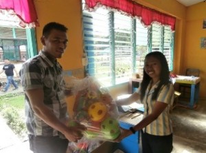 jerwin gives the learning materials to teacher jull