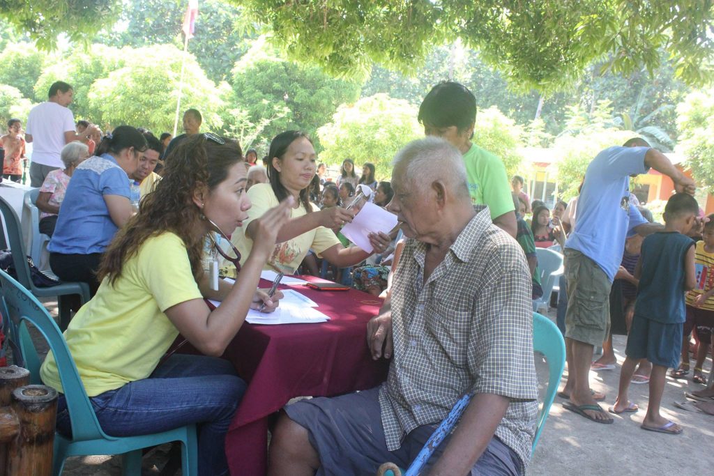 An elderly man listening intently to the doctor