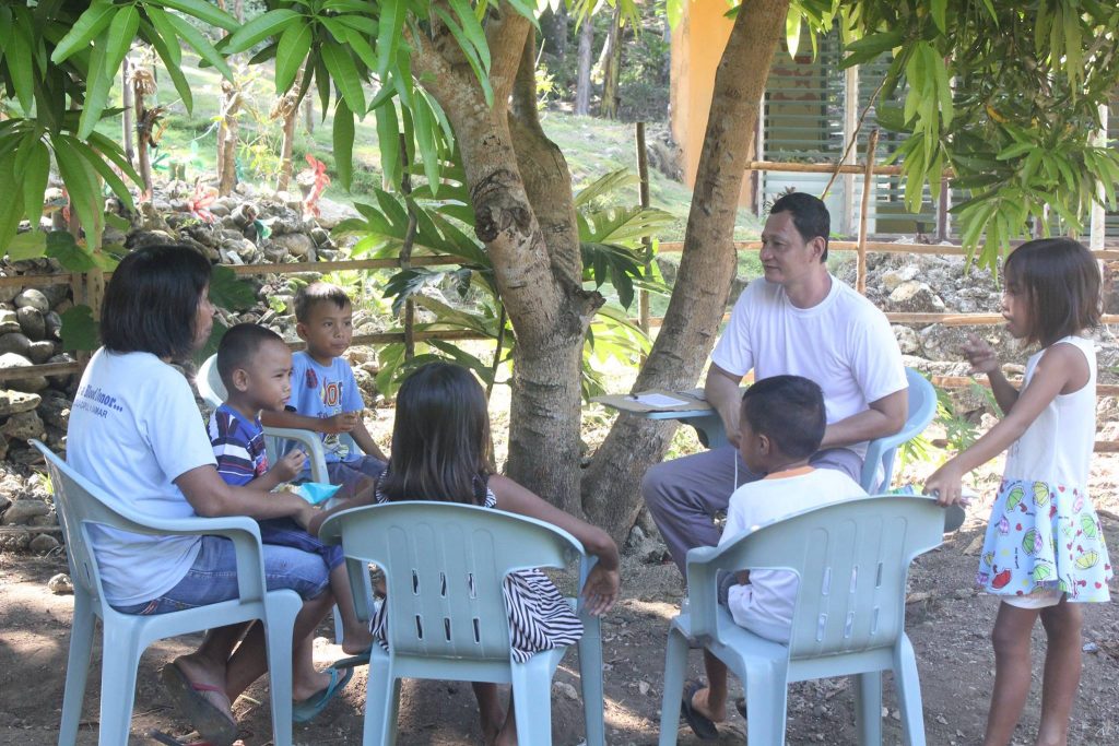 Pastor Richard gives councelling to a mother and her children